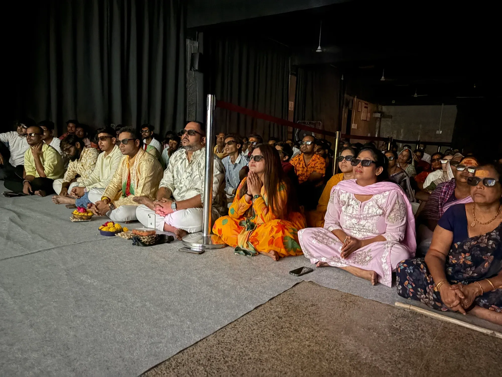 Devotees in 3D glasses with folded hands