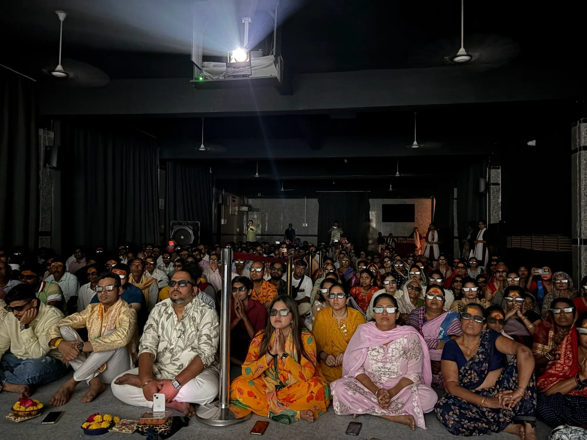 The hall full of seated devotees
